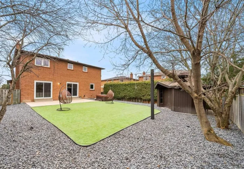 Back garden with a lawn and gravel border.